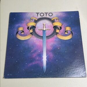 Toto Album Cover with Sword Design